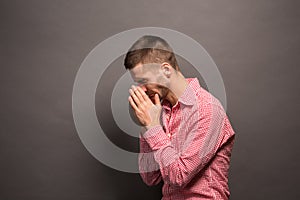 Man covering eyes his face