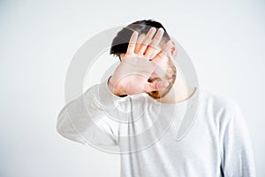 Man covering his face