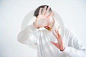 Man covering his face