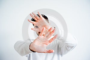 Man covering his face