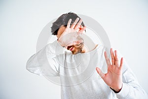 Man covering his face