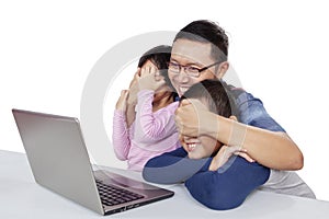 Man covering his kids eyes from explicit content photo