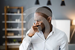 Man Covering His Nose From Bad Smell