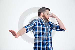 Man covering his nose and showing stop gesture with palm