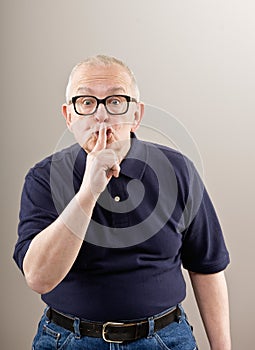 Man covering mouth gesturing