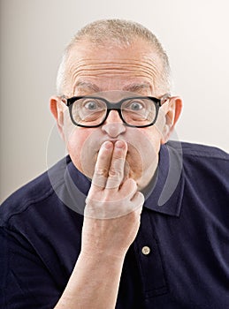 Man covering mouth to keep a secret