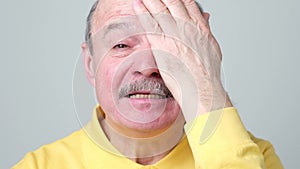 Man covering one eye during vision examination trying to see letters.