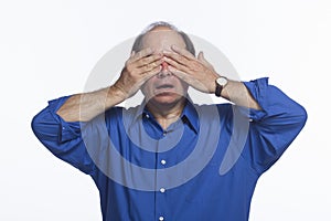 Man covers eyes, horizontal