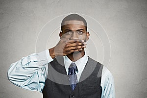 Man covers his mouth, speak no evil concept