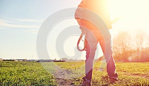 A man cowboy hat and a loso in the field. American farmer in a f