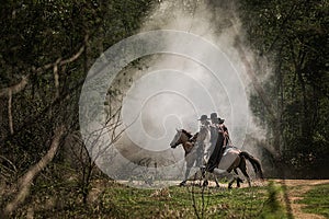 Man in cowboy outfit with his horse