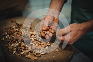 Man cracking walnut with hands