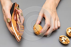 man cracking a walnut with a nutcracker