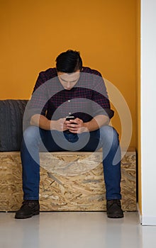 Man in crative box working on smart phone photo