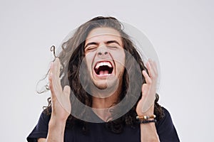 Man, crazy and laugh in studio for joke, comic and silly on gray background. Female person, happy and goofy comedy or