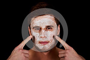 Man with cream moisturizer on his face.