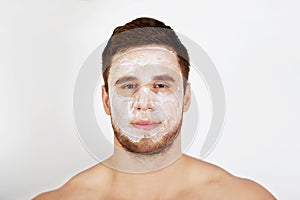 Man with cream moisturizer on his face.