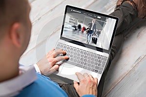 Man creating website for his business by using laptop photo