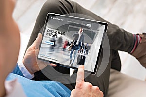 Man creating website by using tablet photo
