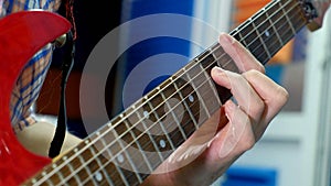 Man creative musician at studio works by playing,singing and recording guitar with notebook and microphone indoor in