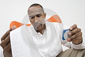 Man With Credit Card And Bill photo
