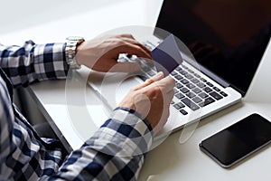 Man with credit card in hand