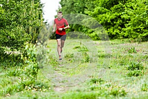 Man cross country running on trail