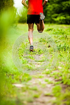 Man cross country running on trail