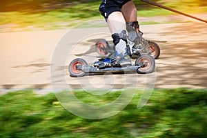 Man cross country skiing with roller ski