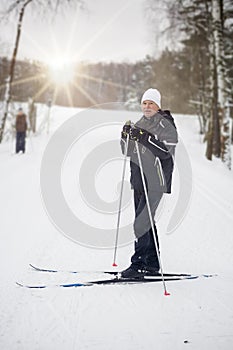 A man on cross-country skis in a winter park