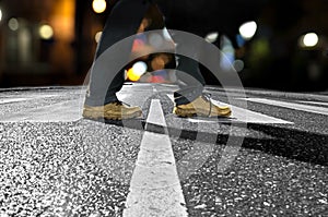 Man crossing street at night