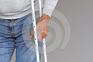 Man with crutch. Close-up. Front view