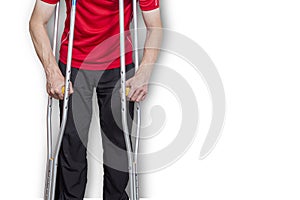 Man on crutches isolated on a white background. Concept: leg injuries, restriction in human movement, limited abilities