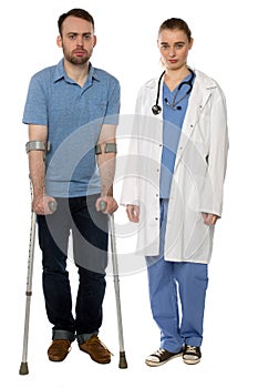 Man on Crutches and Lady Doctor Standing