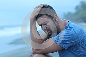 Man crying at the beach