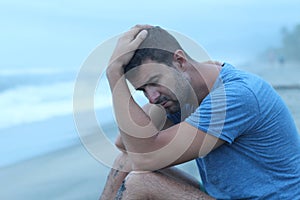 Man crying at the beach