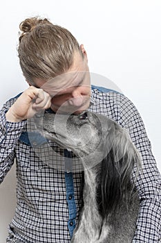 Man crying isolated on white. dog consoles his owner. stayhome concept