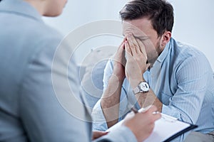 Man crying during psychotherapy