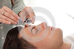 Man during crystal healing session in room