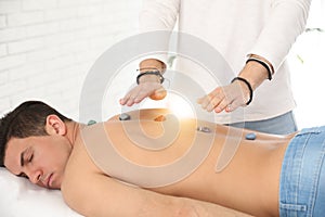 Man during crystal healing session in room