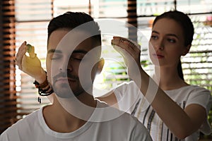 Man during crystal healing session in therapy room