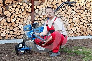 Man with cultivator machine photo