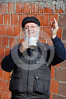 Man with a cup cheers