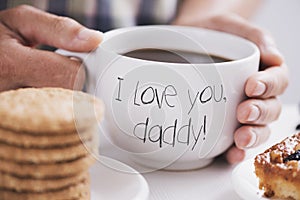 Man with cup of coffee and text I love you daddy