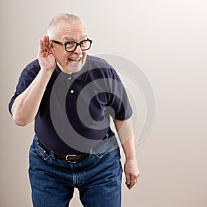 Man cupping his ear photo