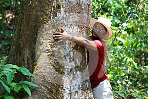 Man curdling tree