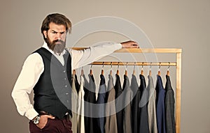 Man in custom tailored suit presenting expensive tailored tuxedo. Man clothing in boutique. Man with suit. tailor in his