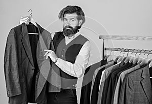 Man in custom tailored suit presenting tailored tuxedo. Man clothing in boutique. tailor in his workshop. Handsome