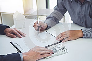 Man customer signing buying home policy document agreement, successful loan contract and salesman receive money after good deal