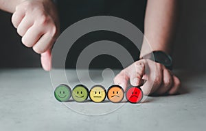 Man customers choose to rate bad emoticon on wood block. Bad review, bad service dislike bad quality, low rating